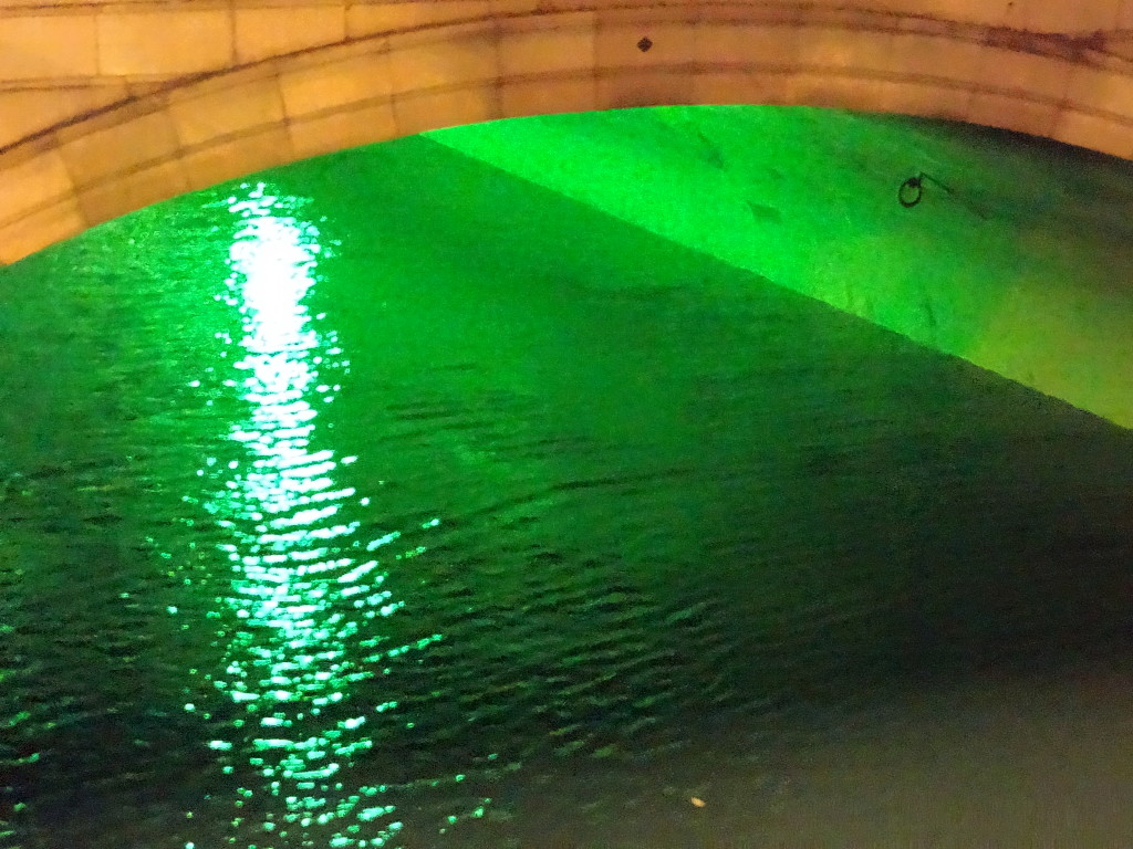 Irish green light reflecting in the River Liffey at the O'Connell Street Bridge