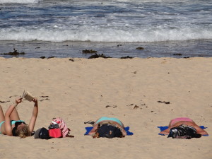 Manly beach girls reading and sleeping