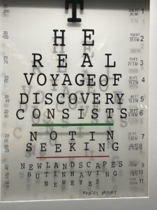 Eye chart letters spelling out a quote of the Real Voyage