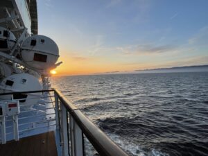 Sunset at sea from deck five with lifeboat on left
