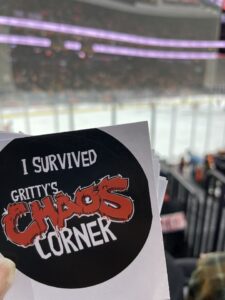 Sticker to wear after the Flyers Game from Gritty's corner with view of ice hockey rink in background