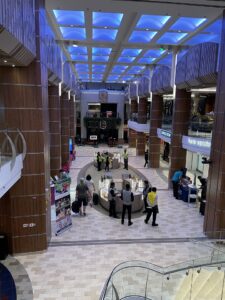Two story atrium of shopping, restaurants and common areas inside the ship