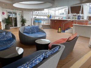 Pool deck seating blue and orange padded outdoor furniture which seats two people