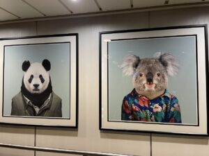 Artwork of Panda in a suit and a Koala in a hawaiian shirt on the stairwell of the ship