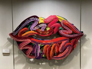 Bright red, purple and splash of yellow painted lips artwork