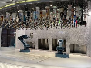 Robot bartender at Bionic Bar on Royal Caribbean with liquor bottles hanging upside down on the ceiling