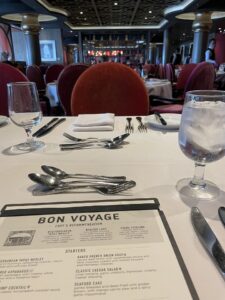 View of set dining table for two with Bon Voyage menu on Royal Caribbean Ovation of the Seas ship
