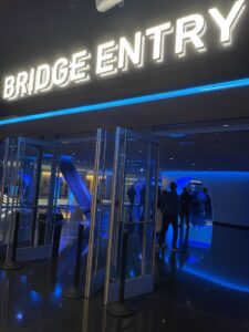 Bridge Entry signed entrance with blue hued lobby in background