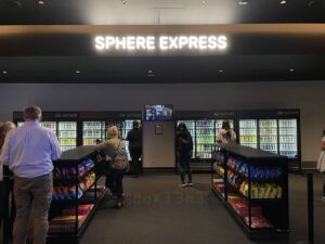Sphere Express with rows of snacks and a wall of cans of water beer and cocktails
