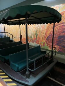 Green canopy boat ride with plastic green seats at The Land Epcot