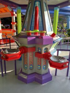Two water fountains in ToyStoryland with many colors purple red neon green