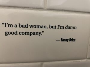 Fanny Brice Quote "I'm a bad woman, but I'm damn good company" on the Mob Museum tile wall in the ladies restroom