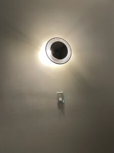Room round light on wall with a switch in middle of white wall