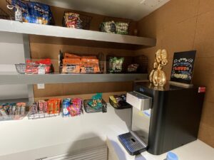 Shelves of snacks next to a water station machine at Aloft Chelsea
