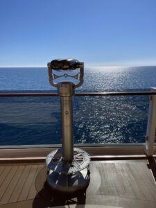 Viewer on cruise ship deck with view of blue skies and blue ocean views