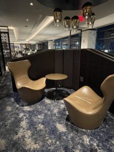 Brown leather lounge seats with table nook at United Polaris lounge