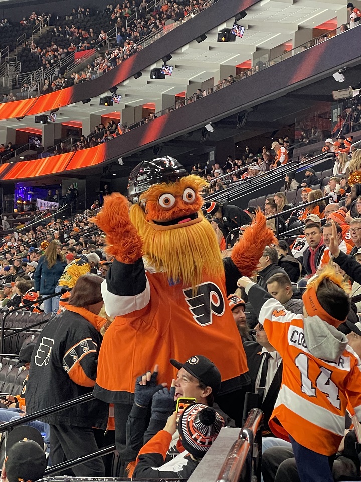 Gritty the orange furry googly eyed mascot of the Flyers doing crowd meet and greets